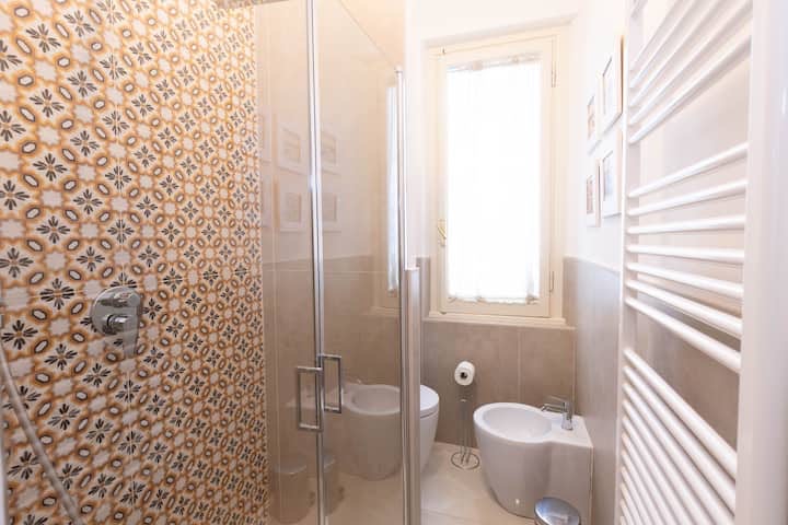 Bathroom with shower and decorative tiles