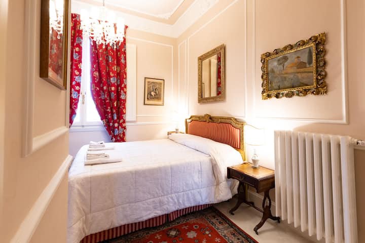 Double bedroom with fine fabric curtains